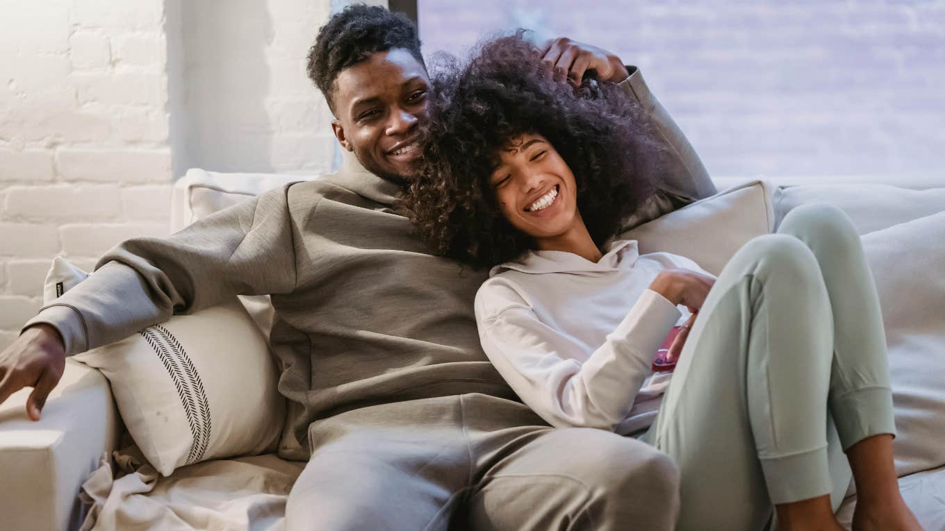 man and woman sitting on a couch