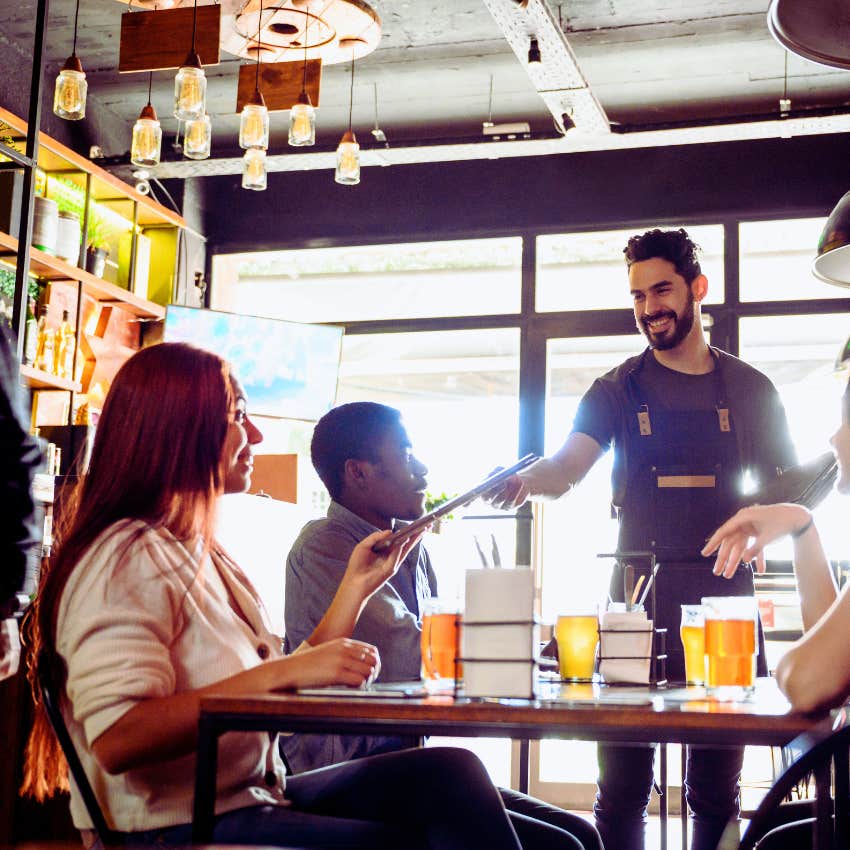 Server handing customer menu