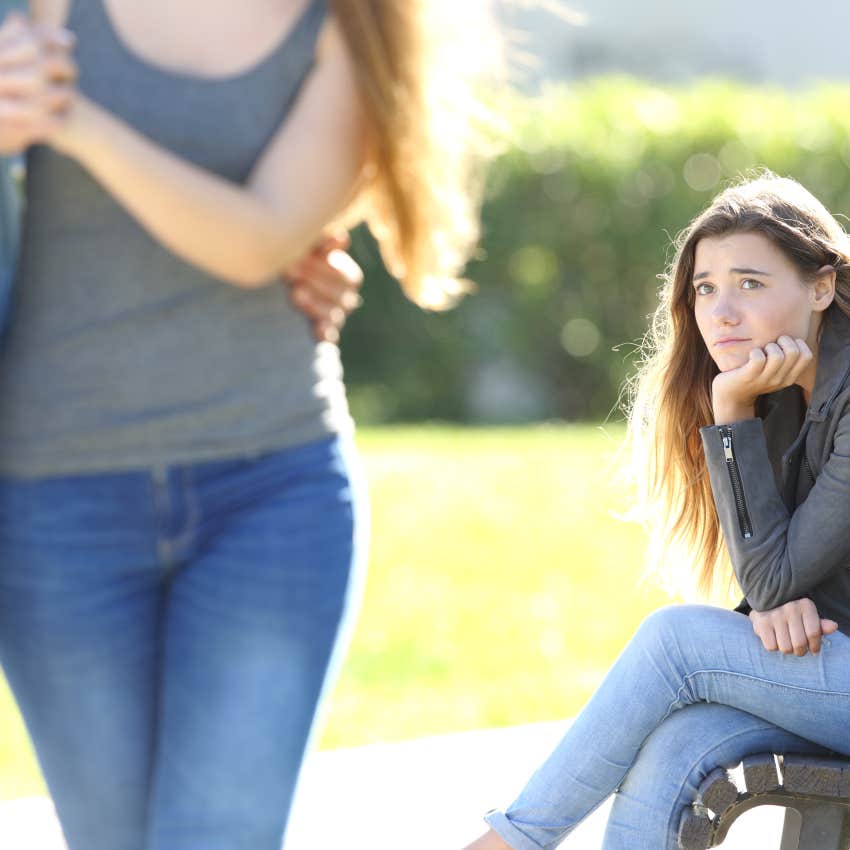 sad woman looking at couple