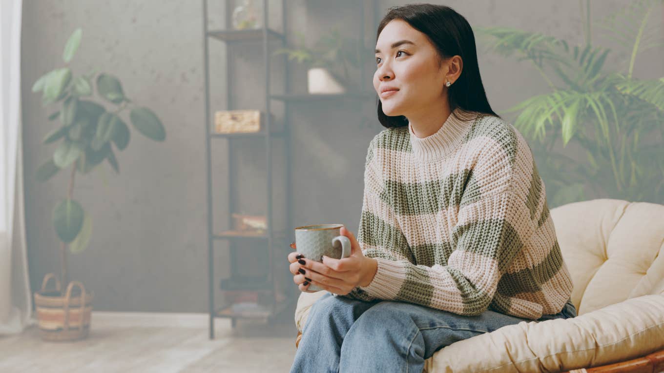 Woman in her "lazy girl era" drinking coffee.