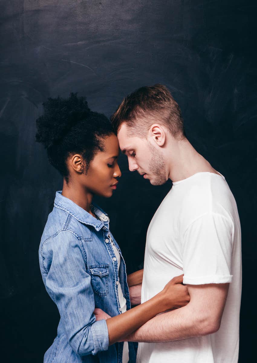 Couple stand forehead to forehead trying to not have a last straw moment