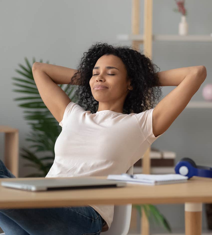 She takes a moment behind her desk for instant relaxation 