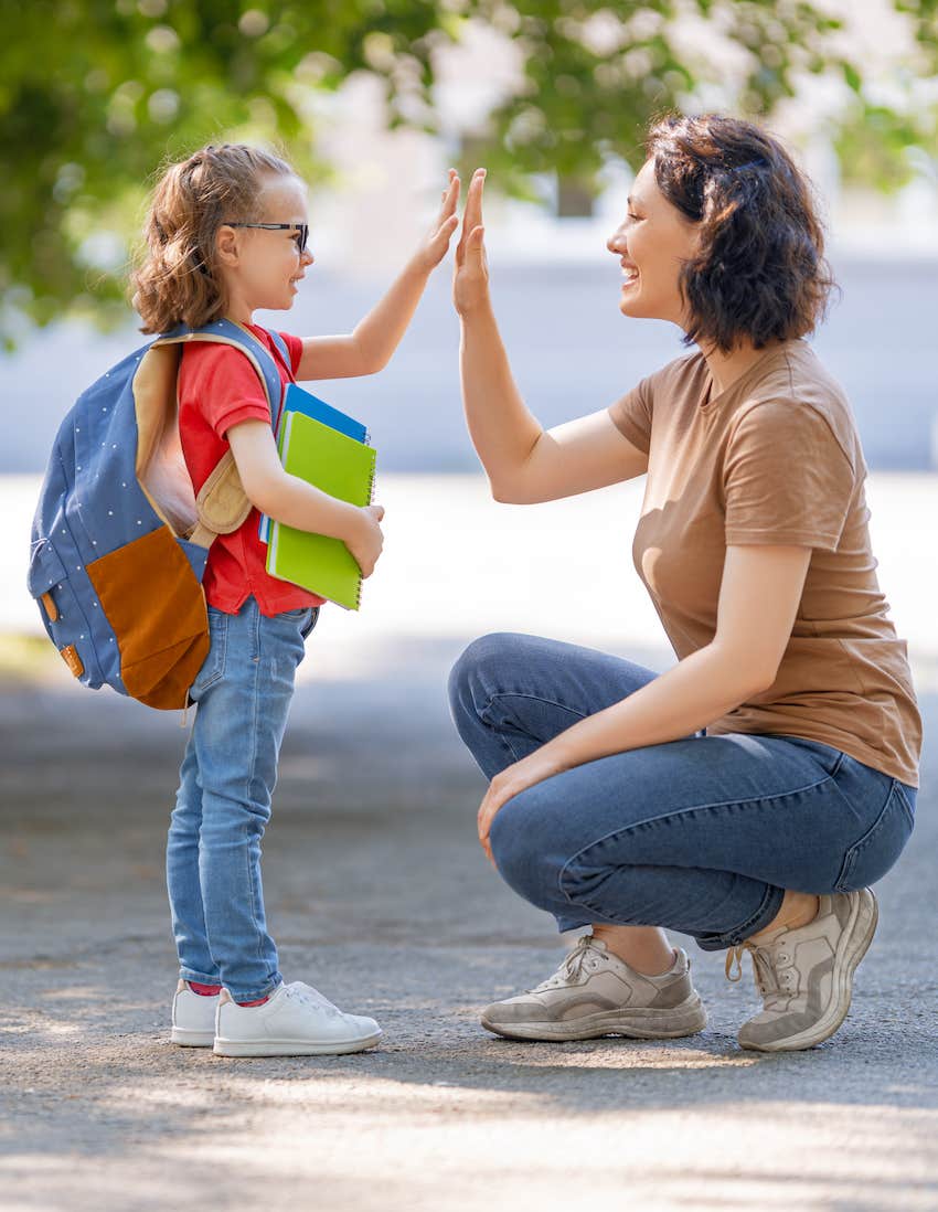 Mom high fives child so they feel less homesick