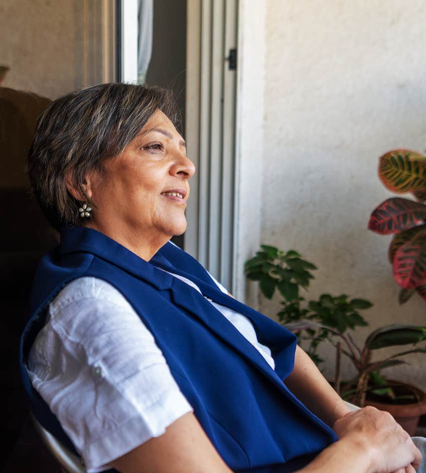 Woman sits and radiates calm confidence