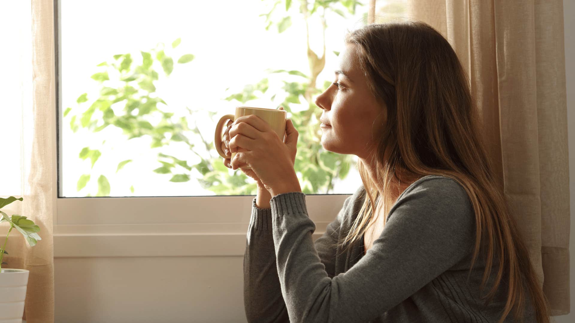 woman all alone reflecting and drinking coffee