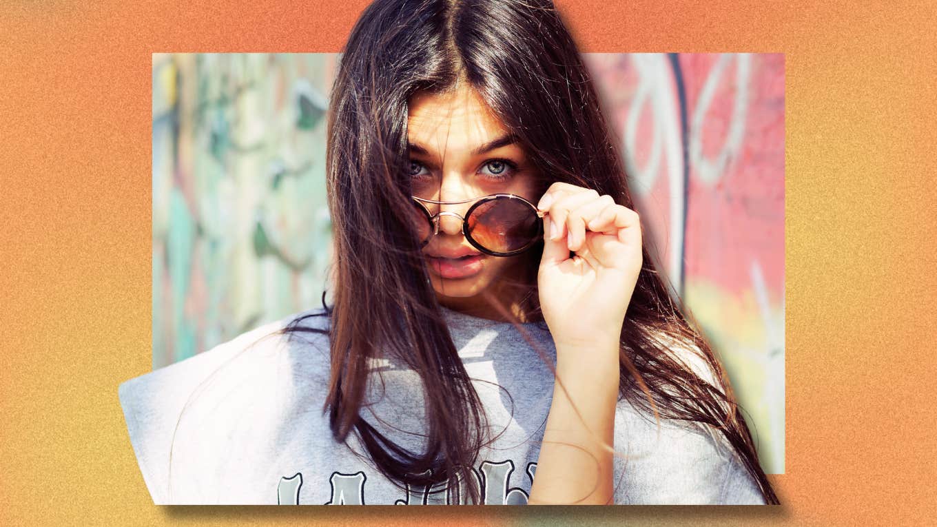 Woman tilting sunglasses with a attitude, needing personal time for self care, reflection