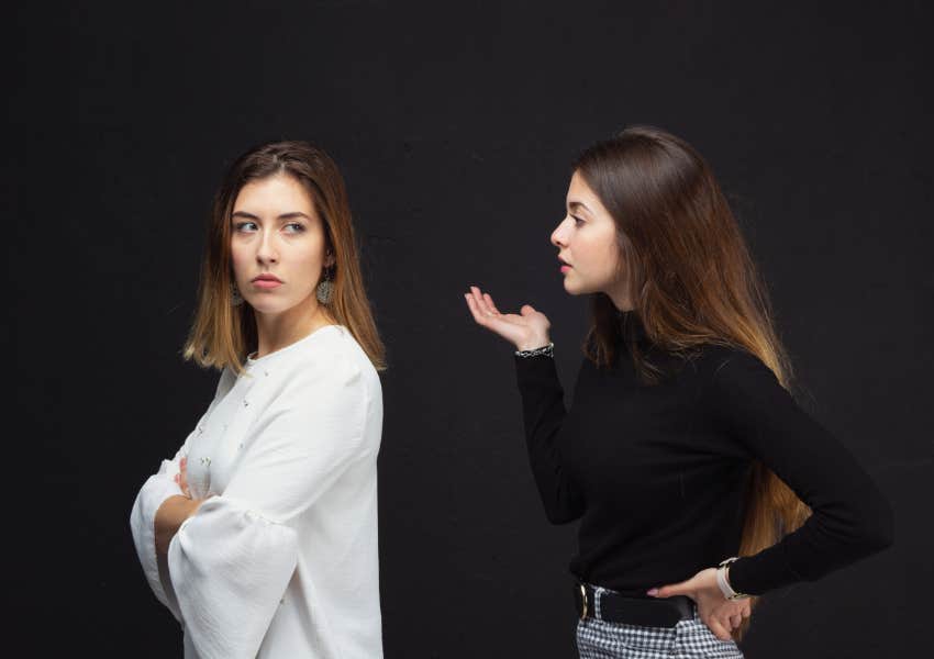 two sisters arguing about disagreement in front of black screen