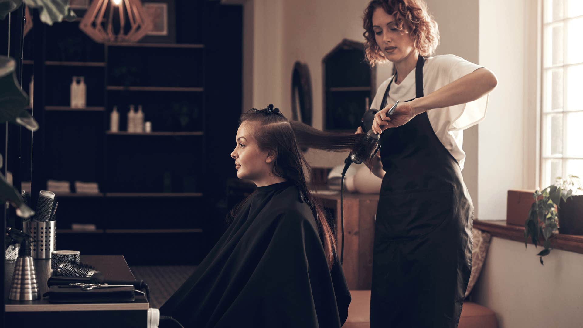 woman putting in effort with hairstyle client