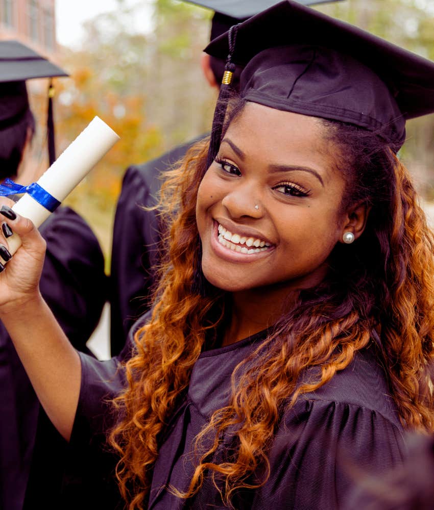 smiling college grad holding diploma