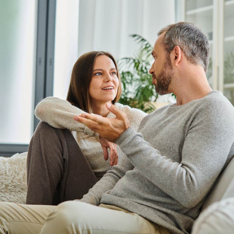 couple having conversations while sitting on couch