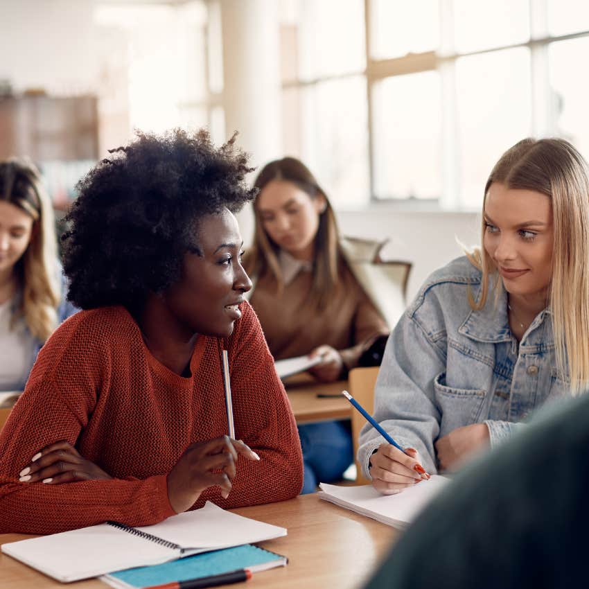 Students talking in a classroom. 