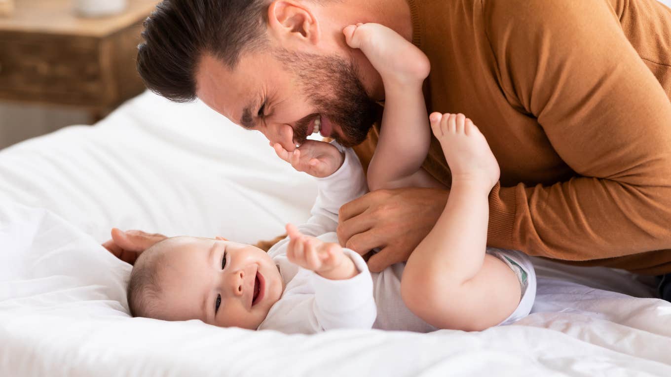 dad on paternity leave snuggling baby