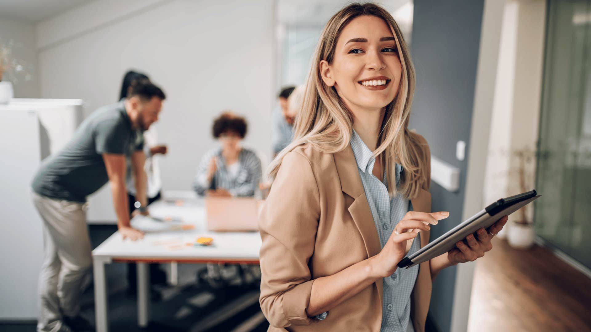 woman smiling while on ipad