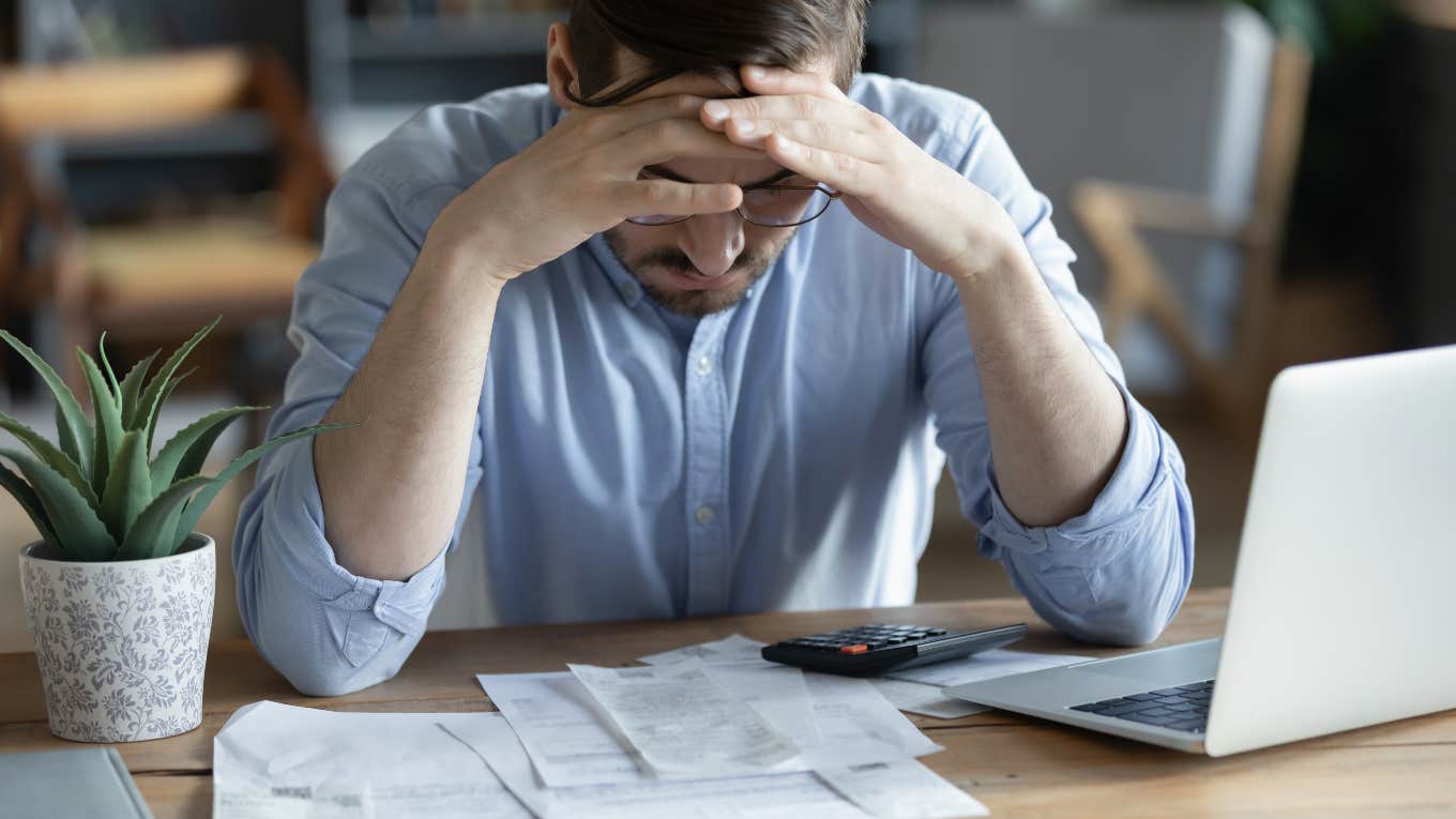 man frustrated while paying bills