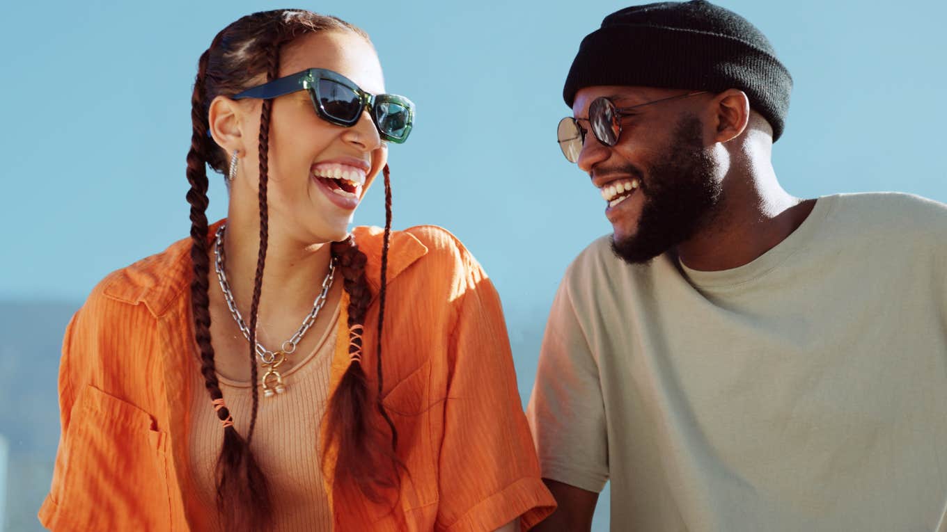 Couple smiling and talking about dating bucket theory. 