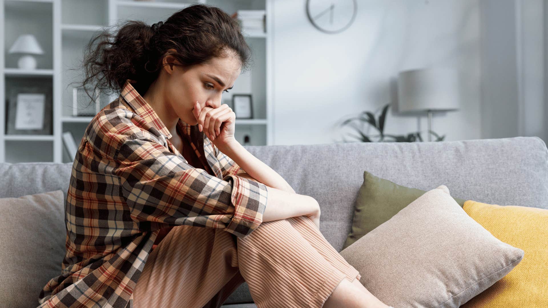 introvert woman curling up on couch