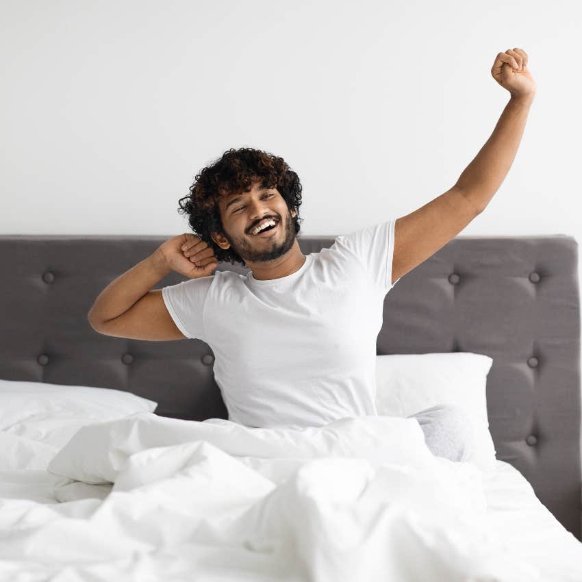 man stretching in bed