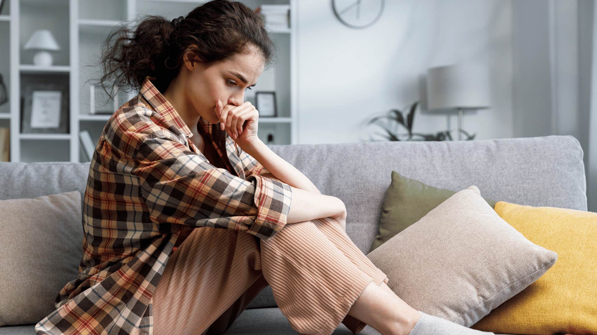 anxious woman sitting on the couch