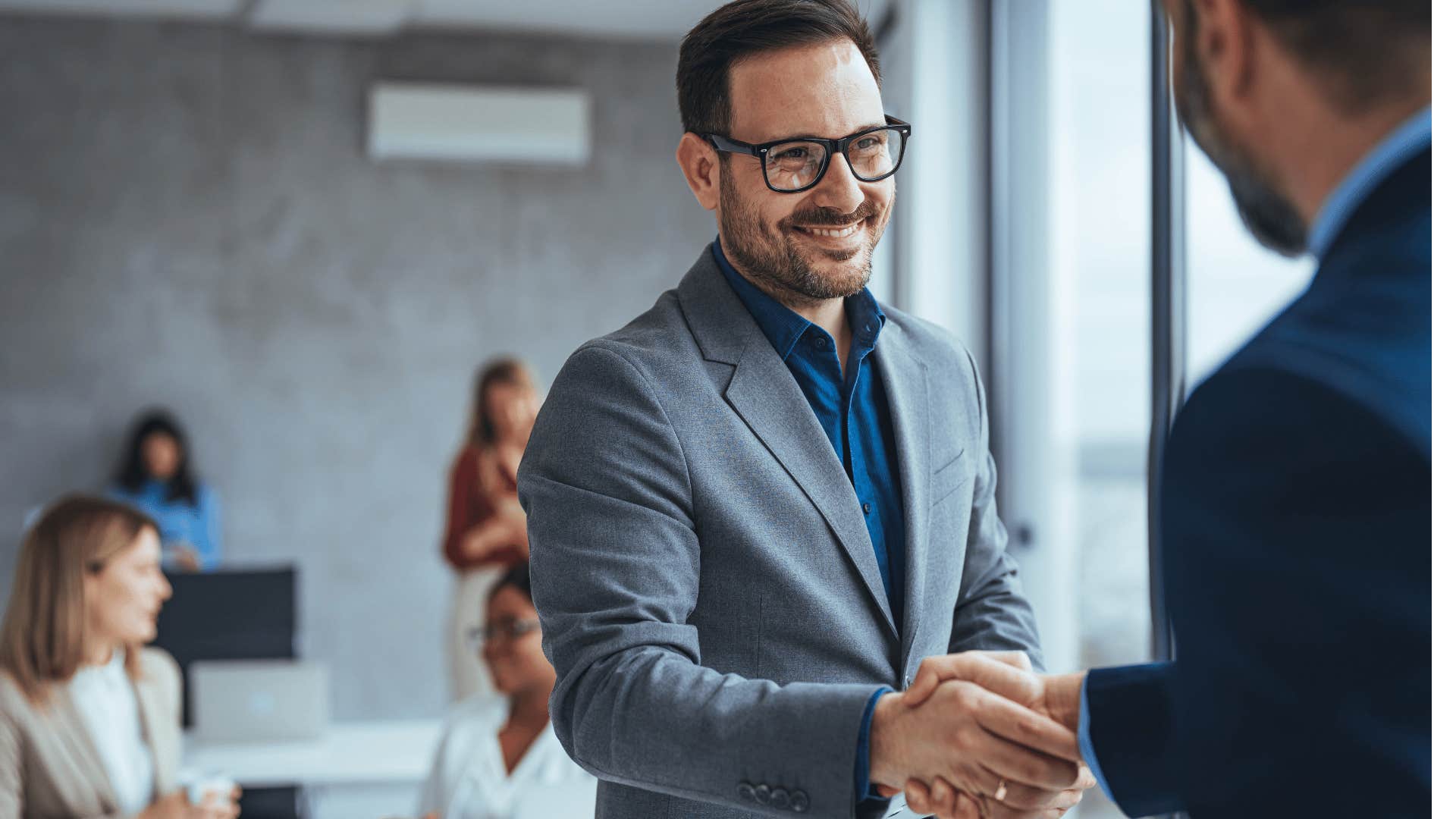 man shaking other mans hand 