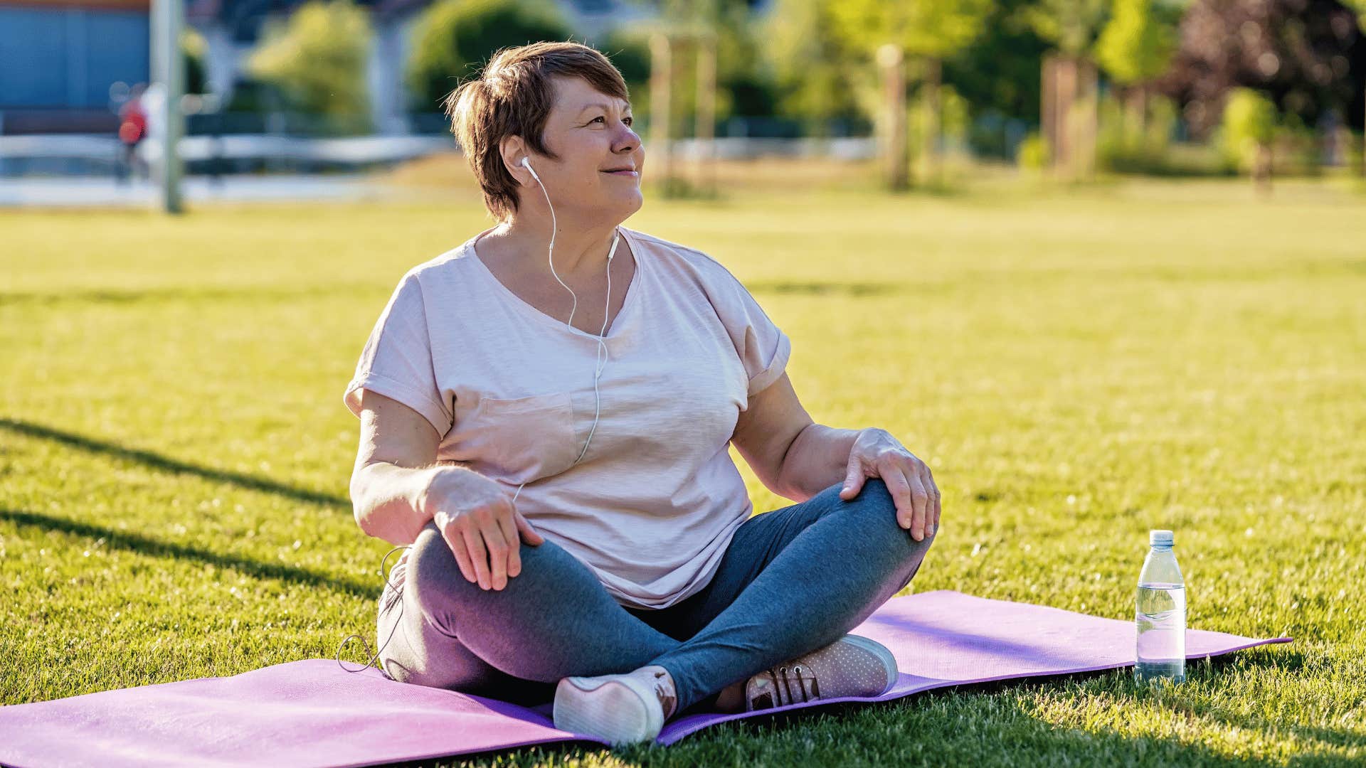 woman sitting on mat taking a break 