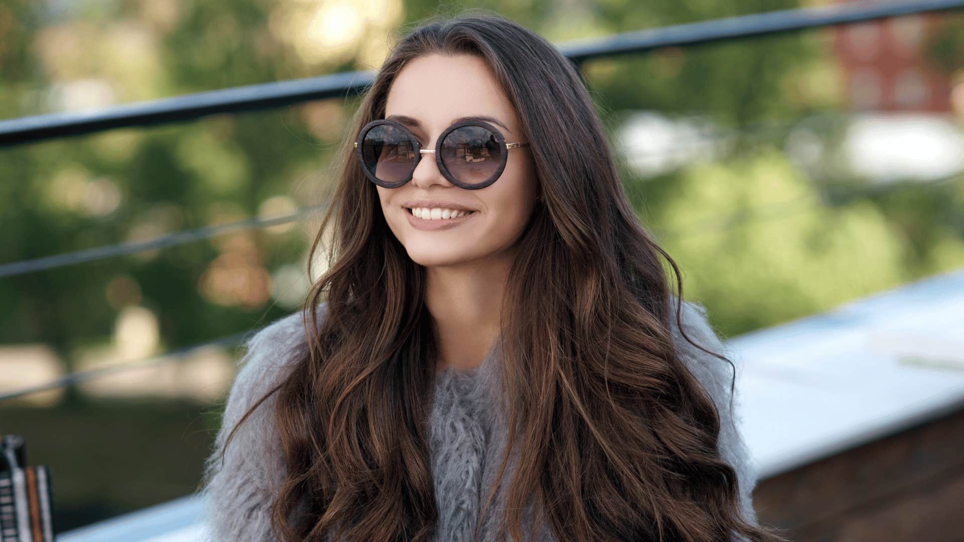 woman wearing sunglasses and smiling