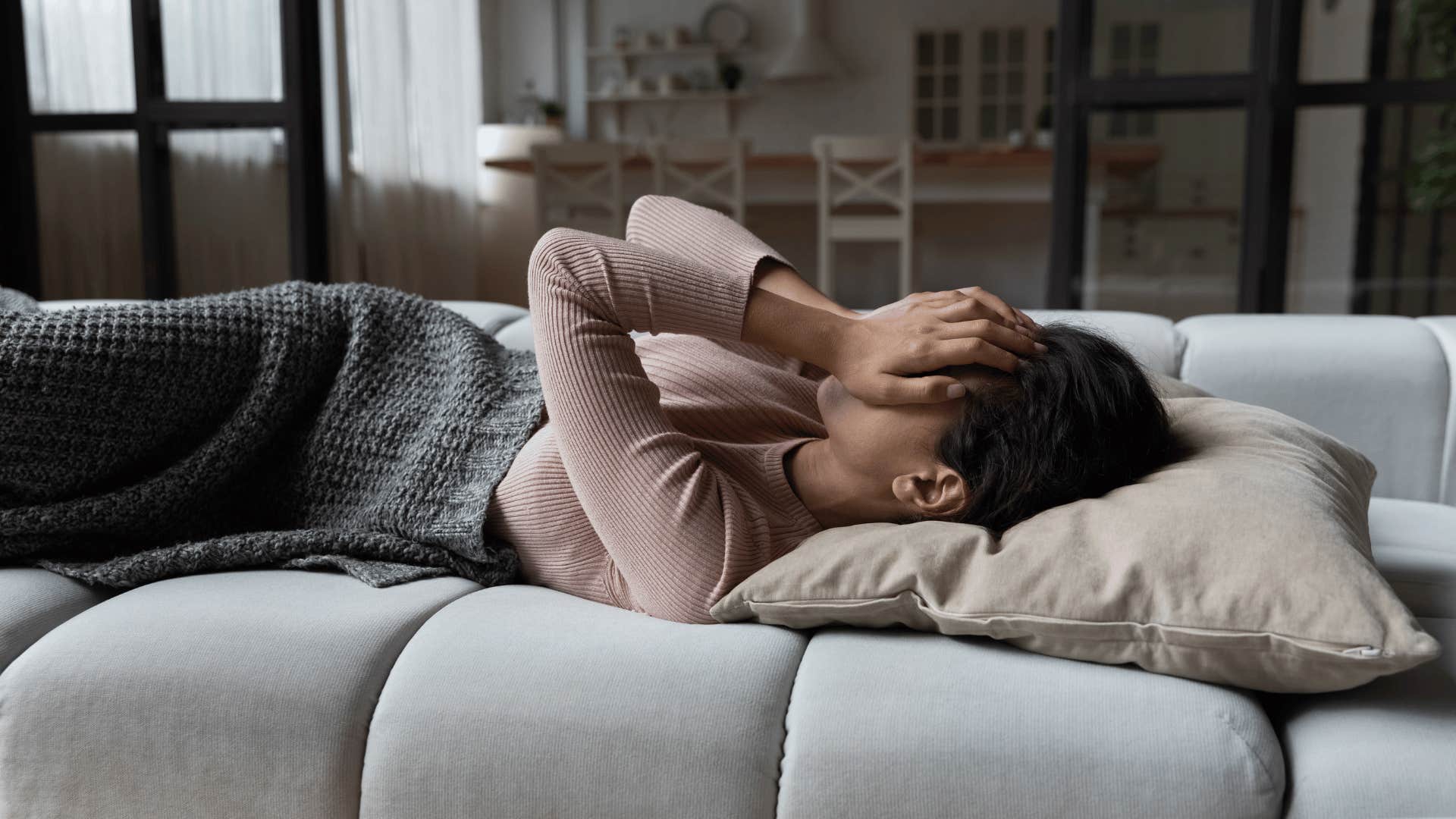 woman upset and hiding her emotions from the people around her