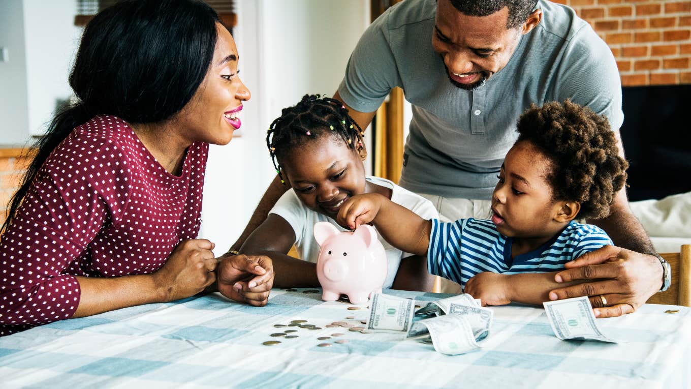 parents and two kids saving money in a piggy bank