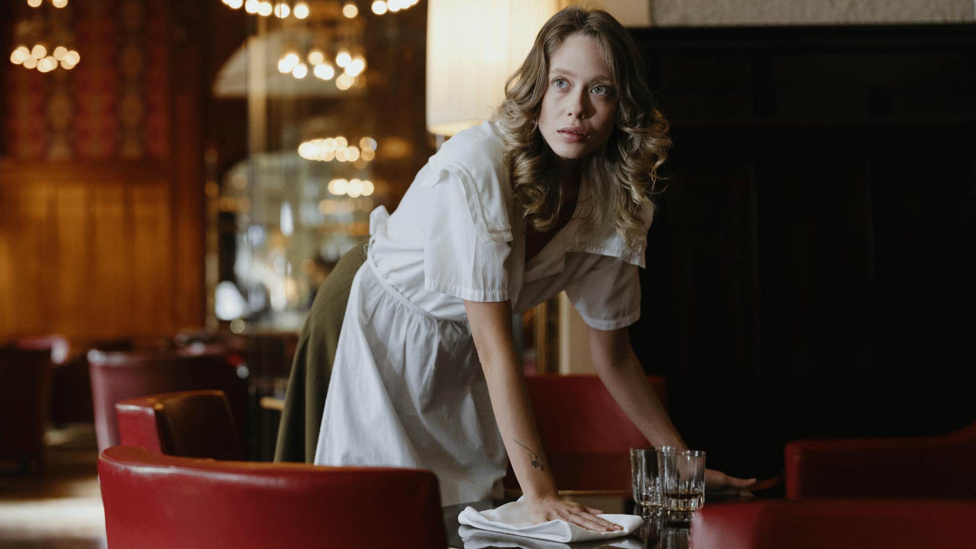 woman cleaning restaurant table