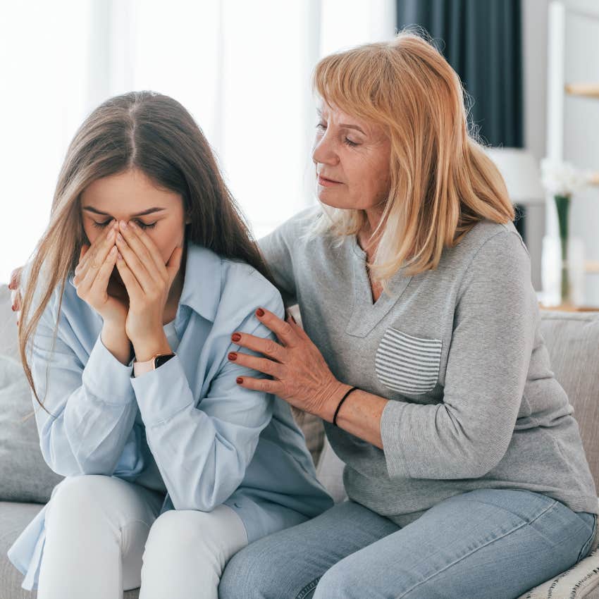 College adult child upset sitting next to parent. 