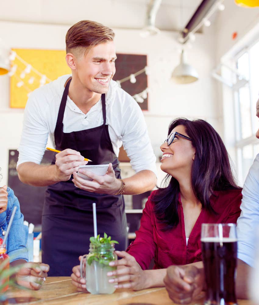 Waiter taking customer orders