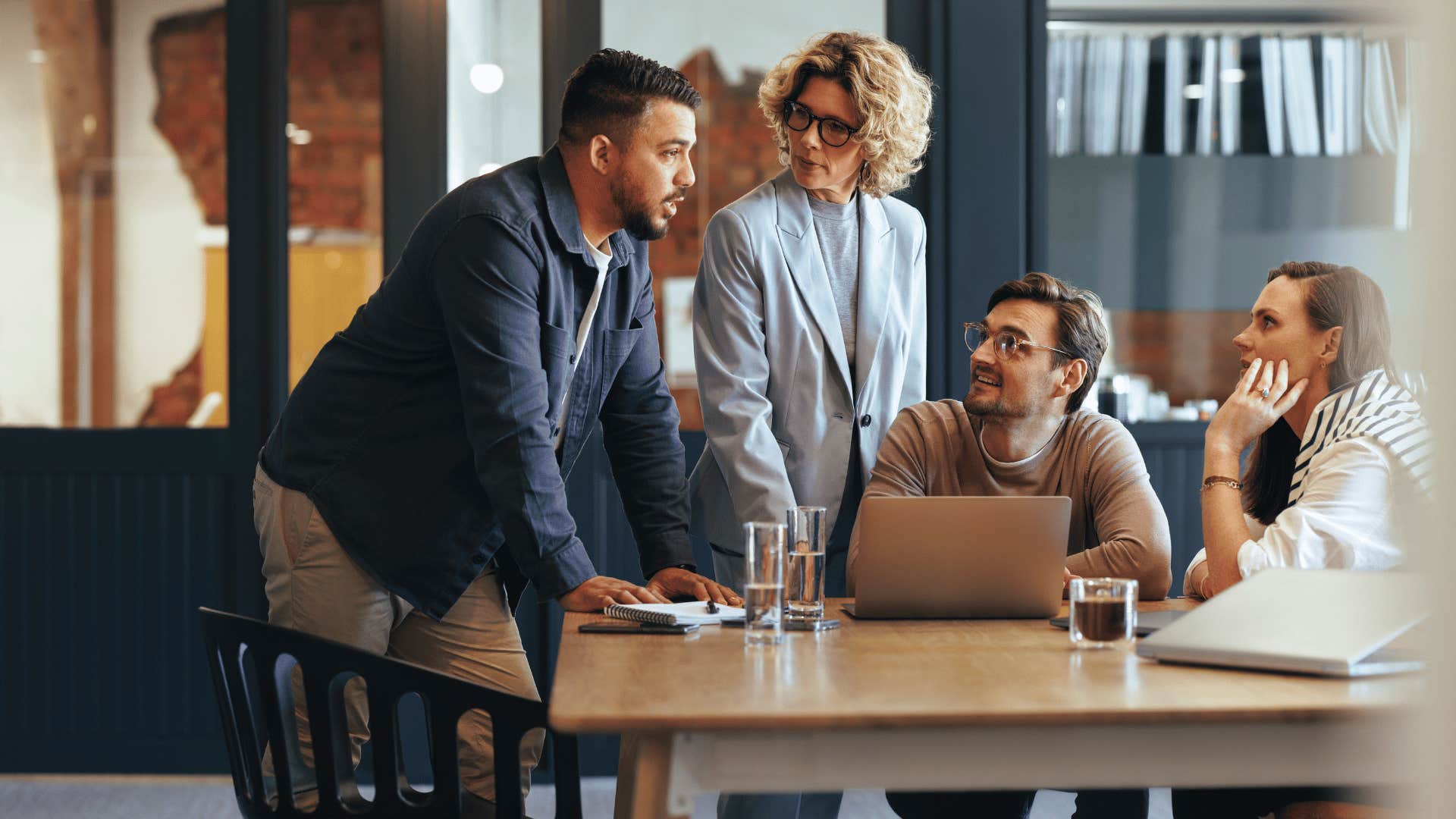 worker managing team in meeting