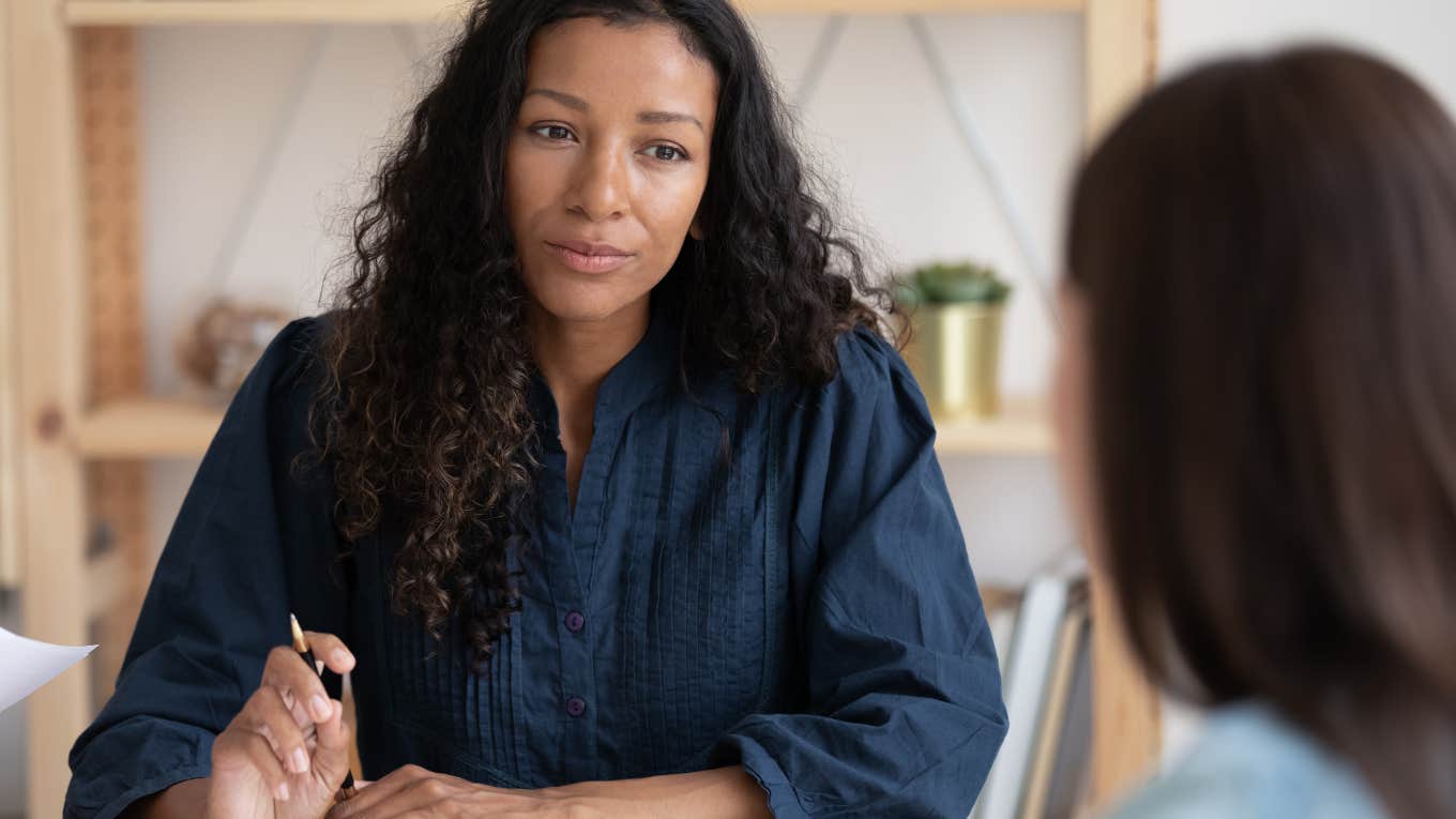 boss quietly managing and talking to employee