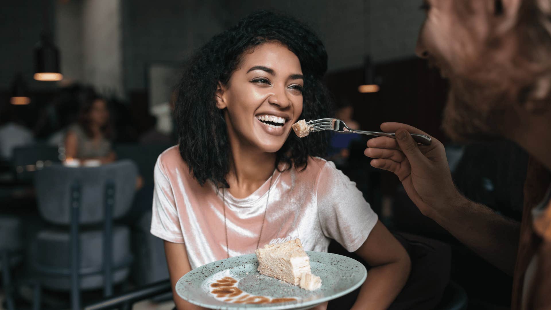 woman smiling and eating without saying a word