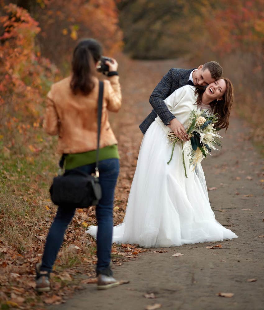 Wedding photographer taking pictures of bride and groom