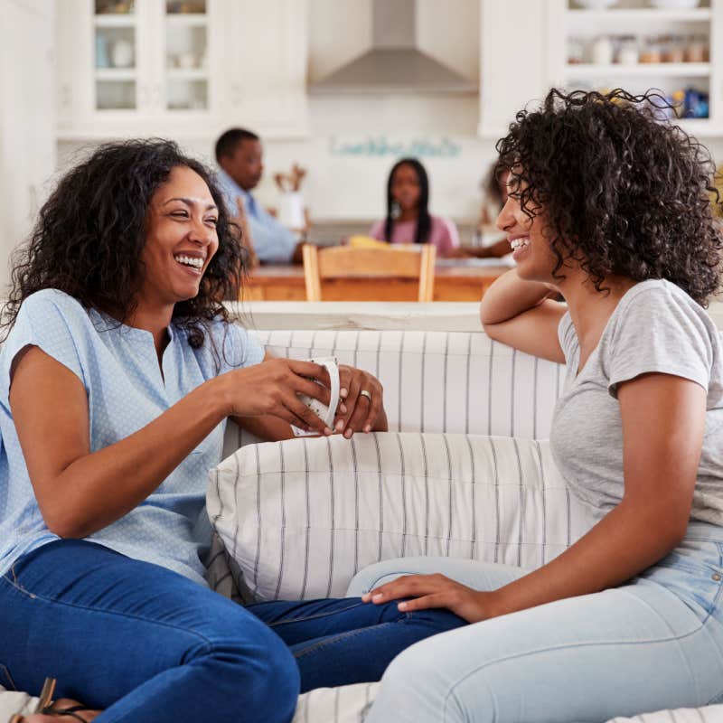 mother talking with daughter on couch