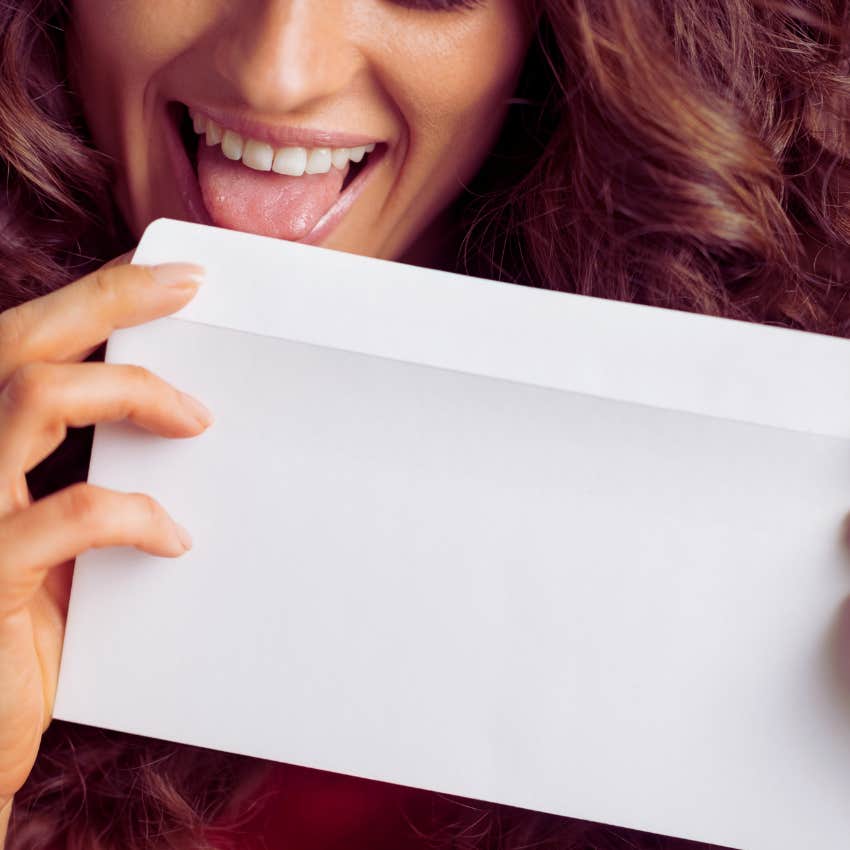 woman licking envelope