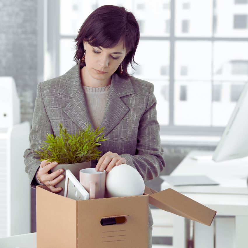 woman packing up her desk after getting fired