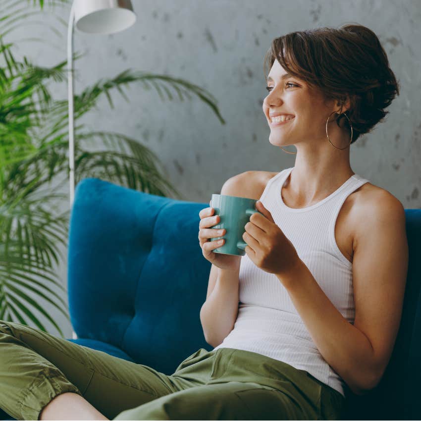 Woman relaxing with coffee at home. 