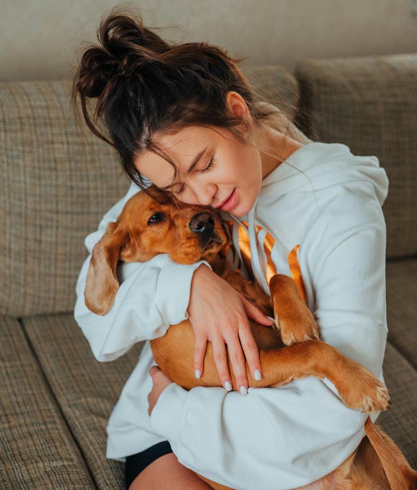 woman hugging a dog 