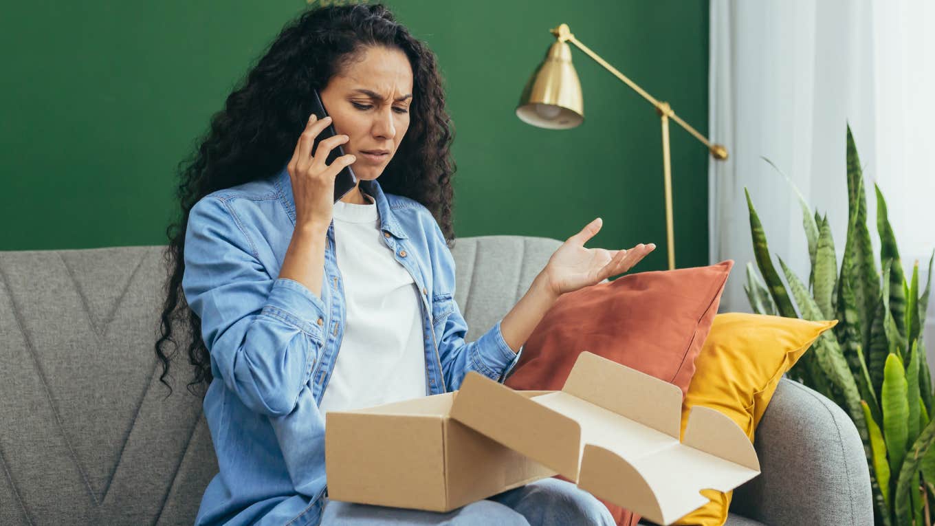 Woman looking confused in a scam package. 