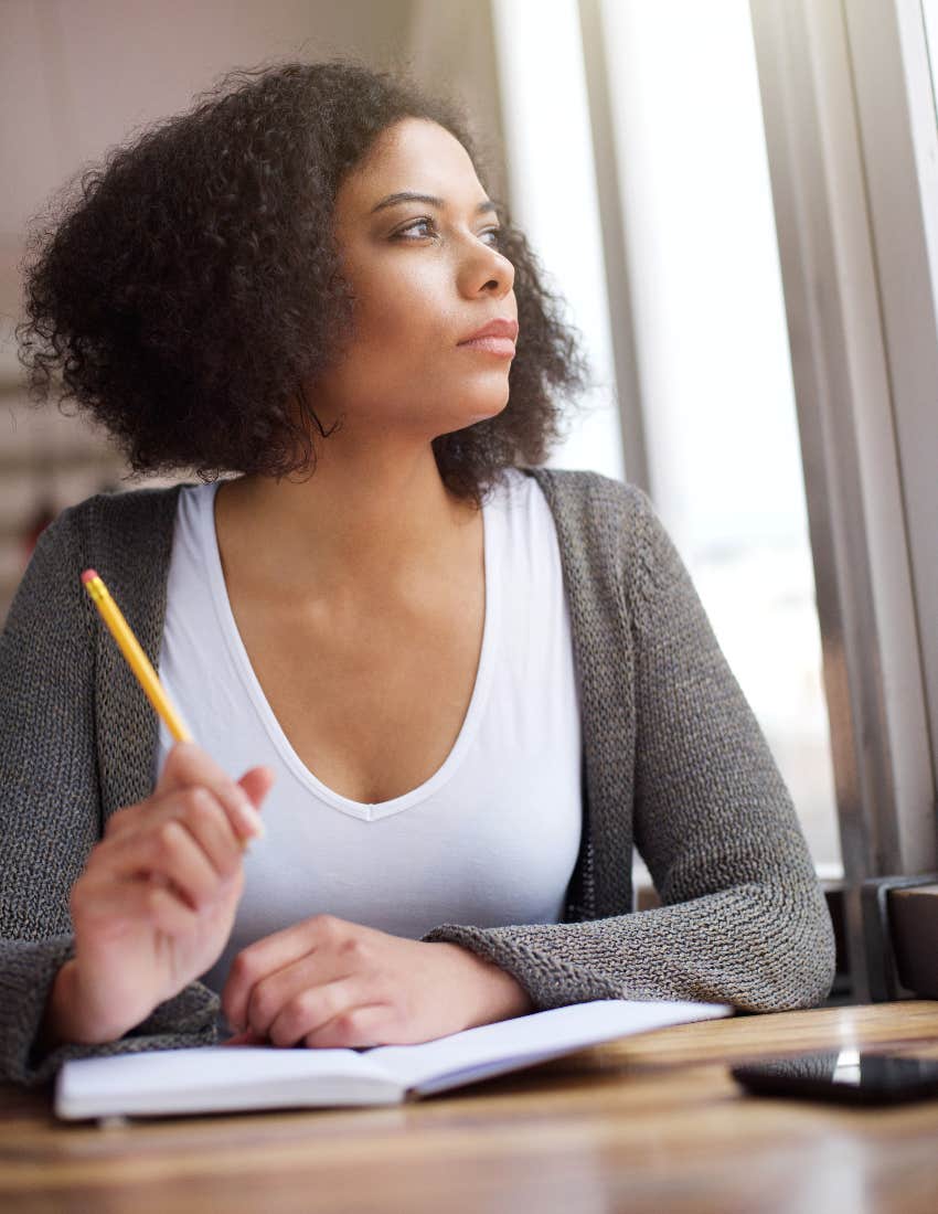 woman writing solutions to worries