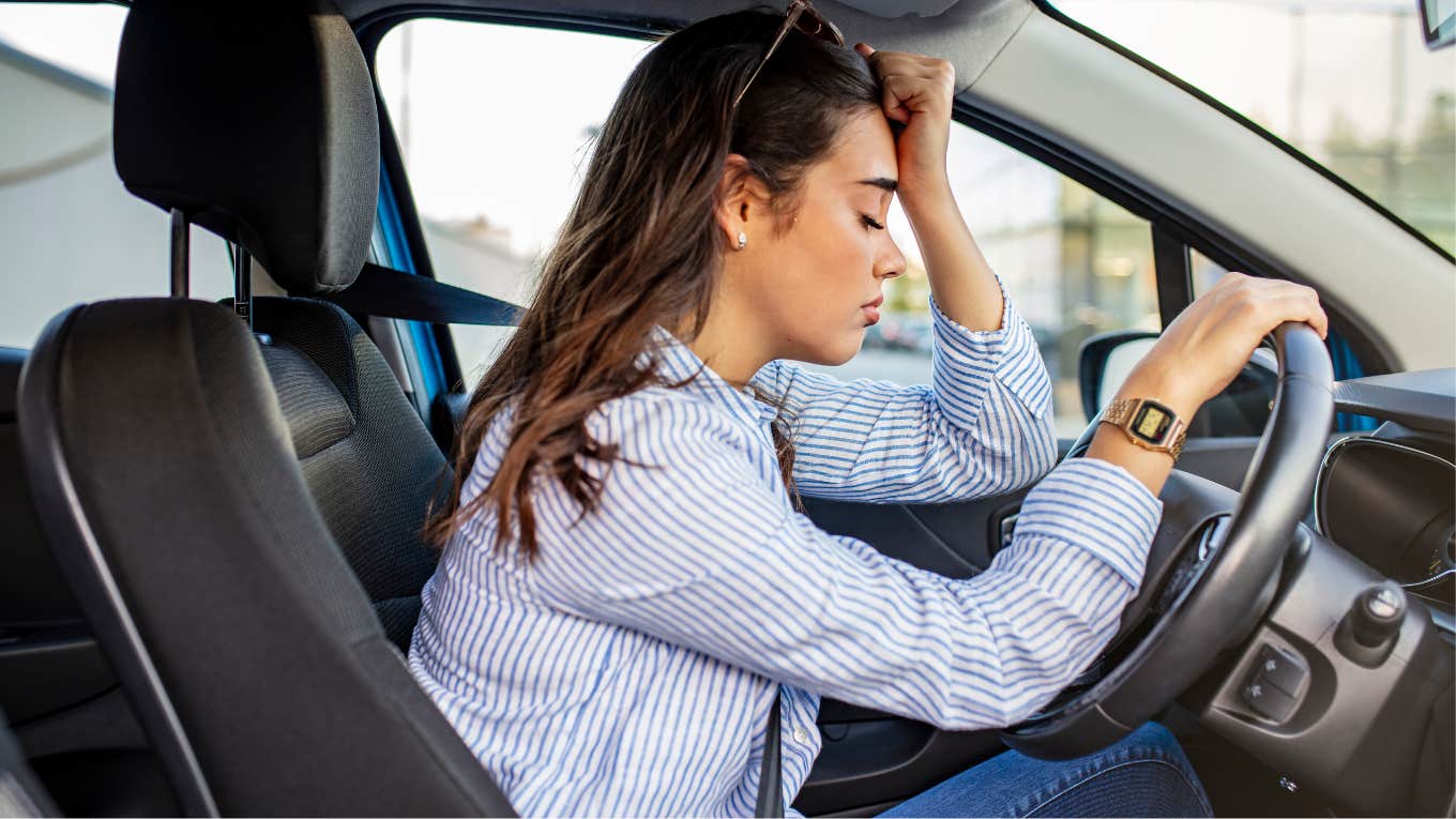 Woman sitting in her car near the mechanic. 