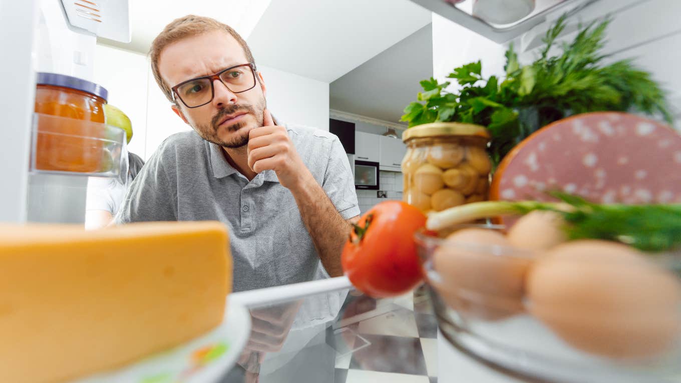 Man looking in fridge to pack lunch