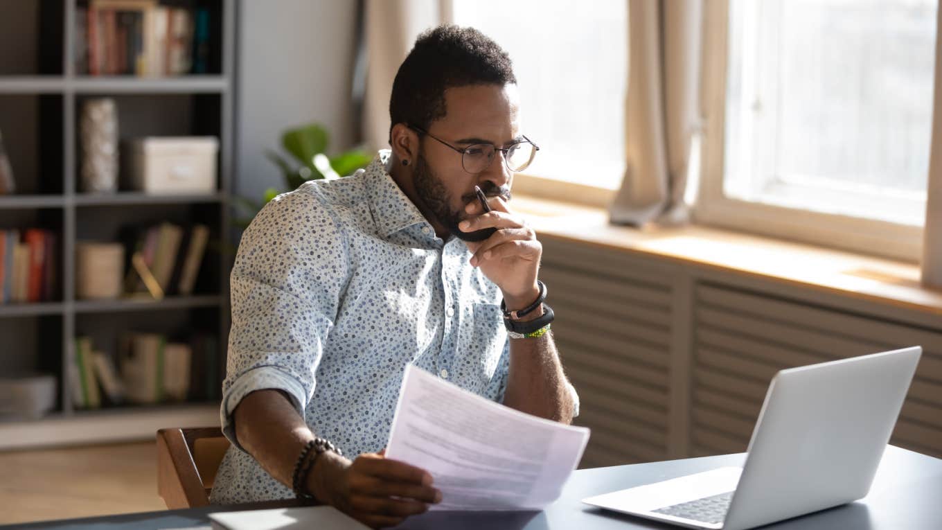 focused serious man working on computer in office