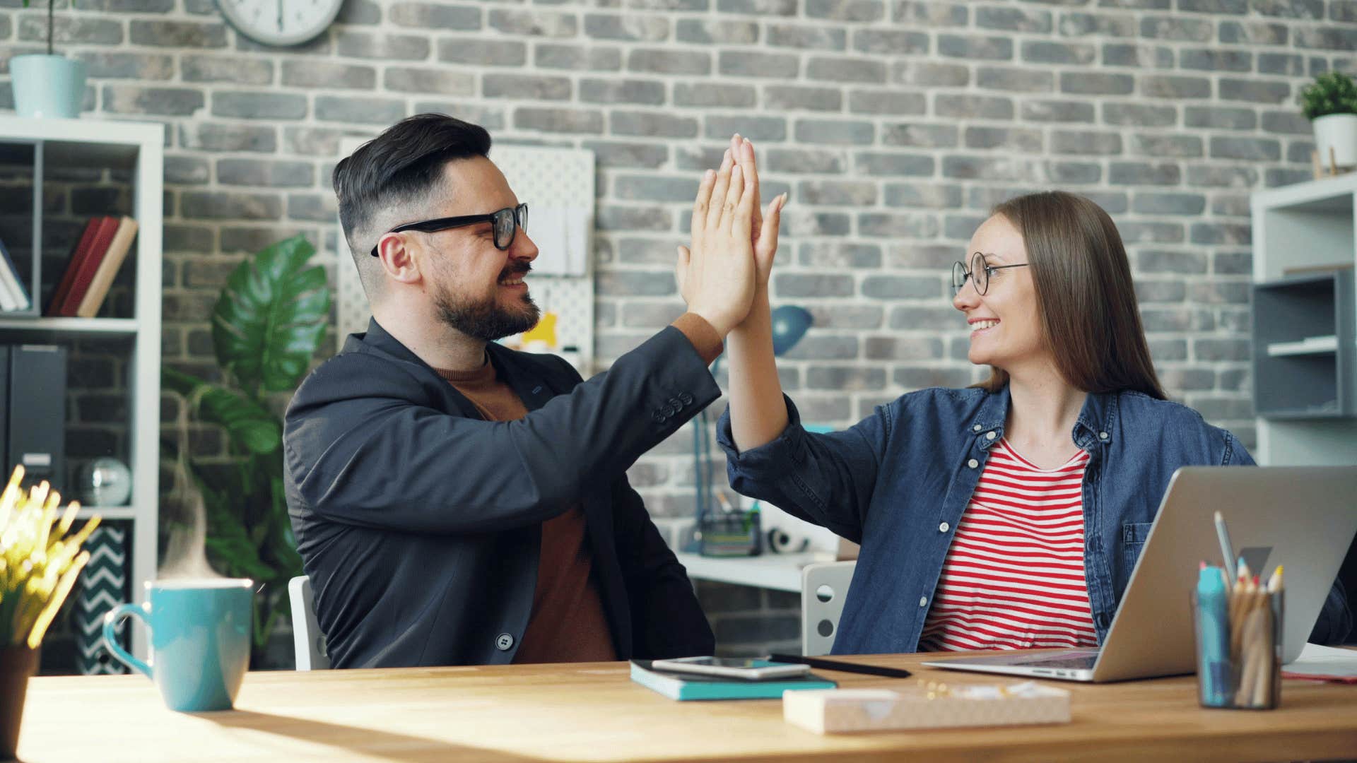 man offering high five to woman