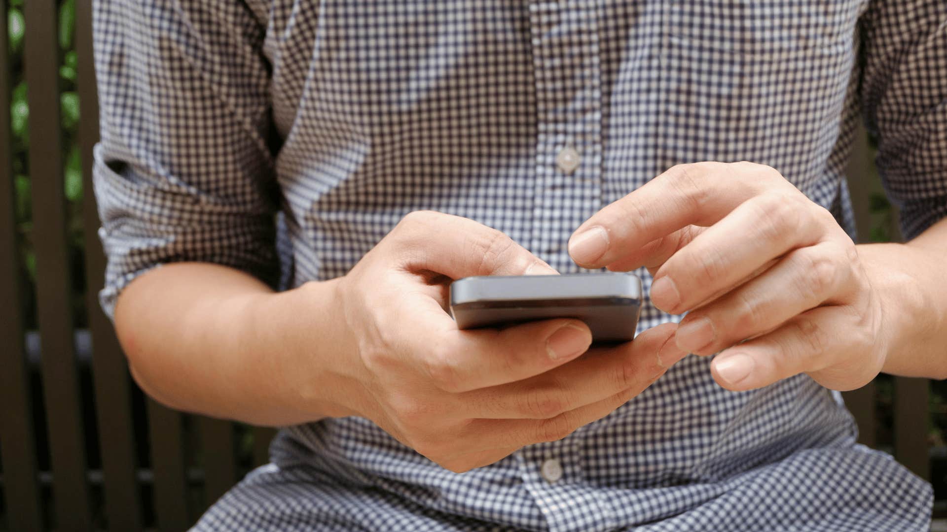 man scrolling through phone