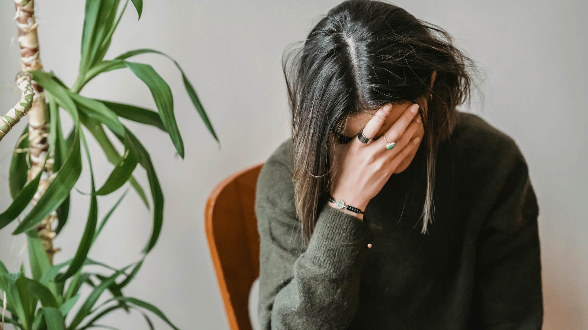 upset woman hand covering her face