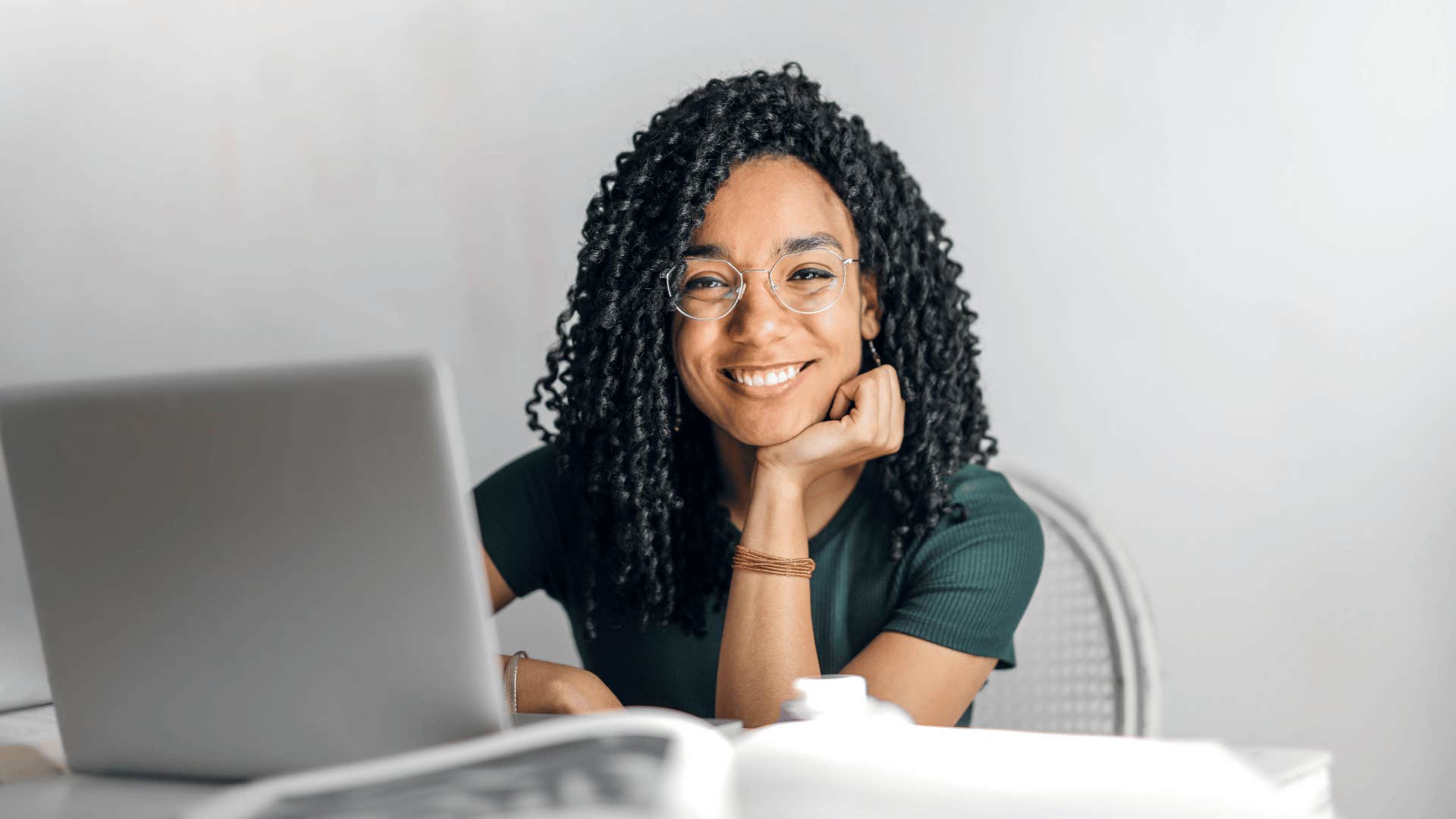 open laptop in front of smiling woman