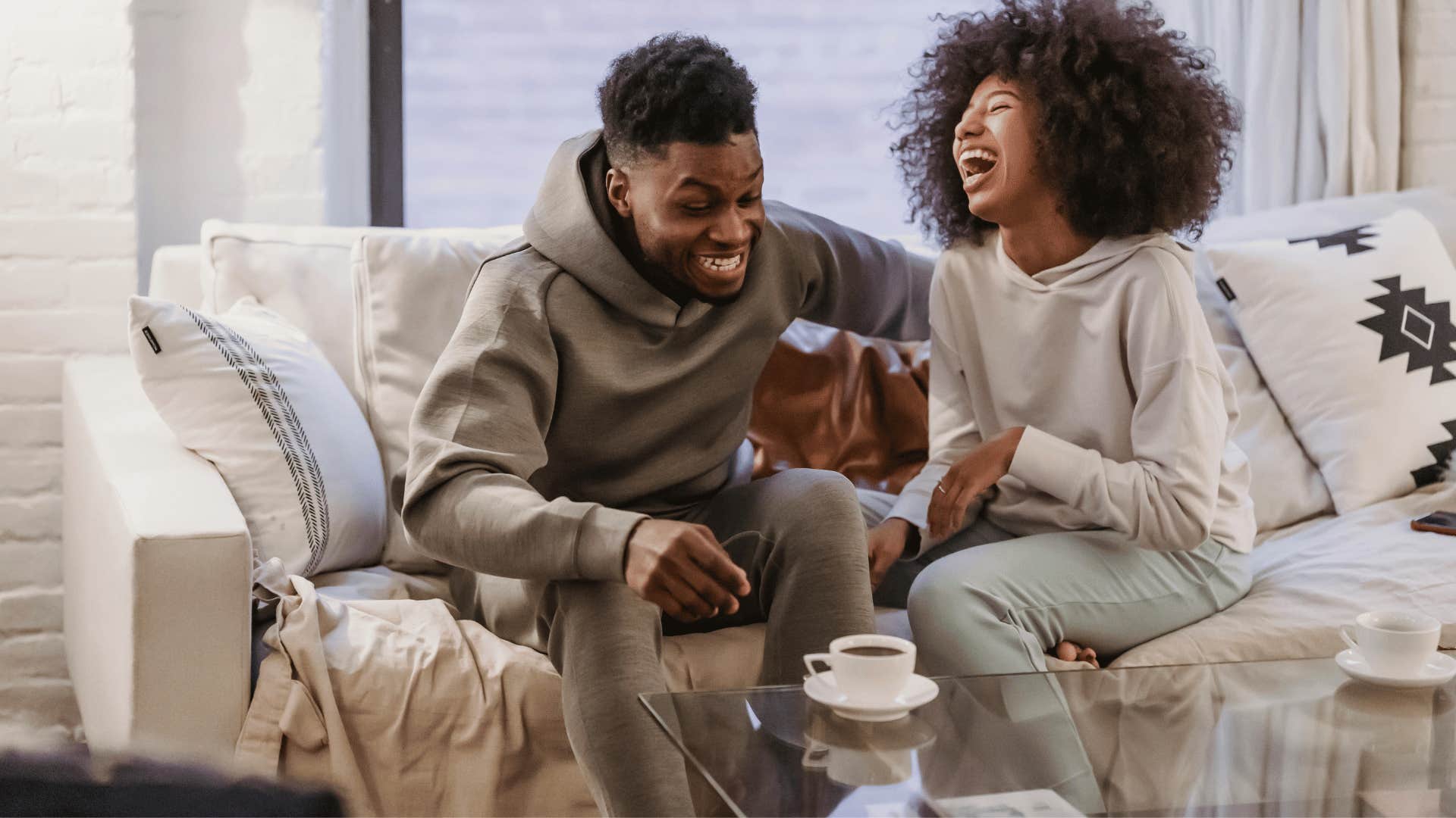 couple laughing together on couch