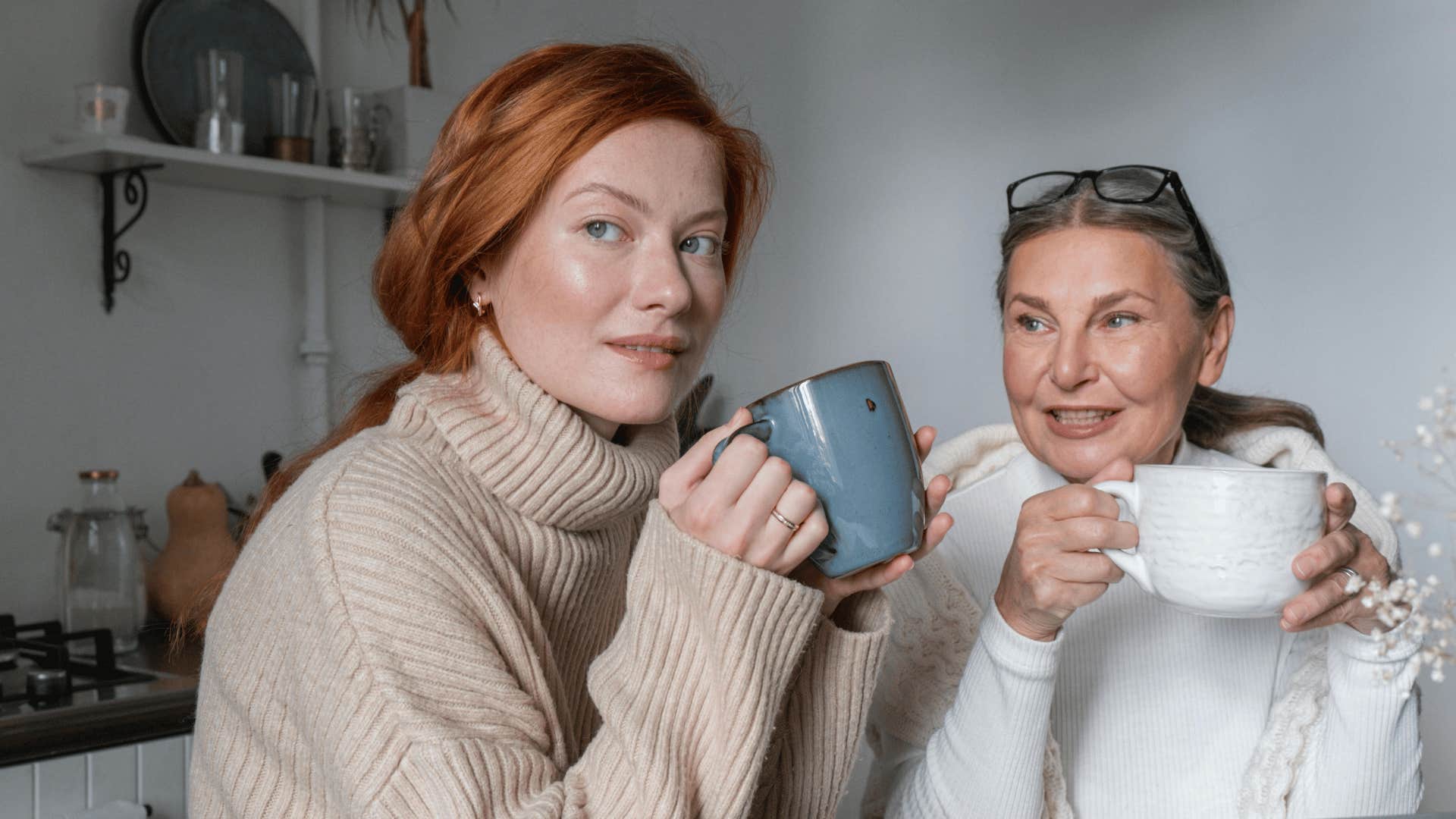 mother and daughter drinking out of mugs together